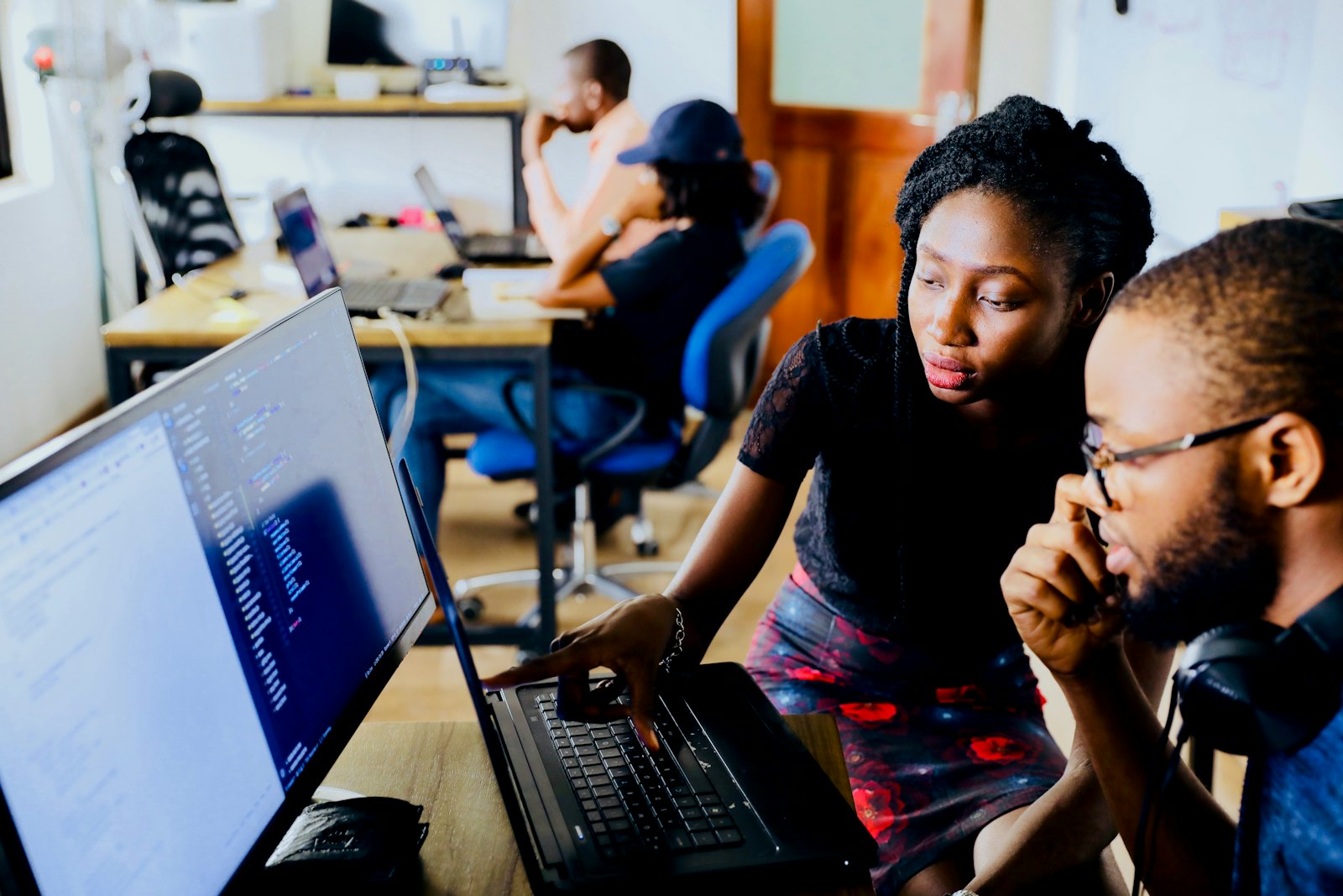 Two developers reviewing an automation on screen